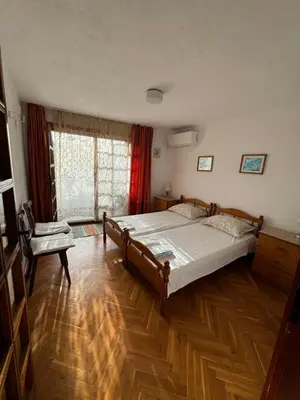 a bedroom with a large bed and a chair at obzor, orkinos in Obzor
