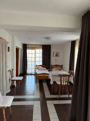 a living room with a bed and a table and chairs at obzor, orkinos in Obzor