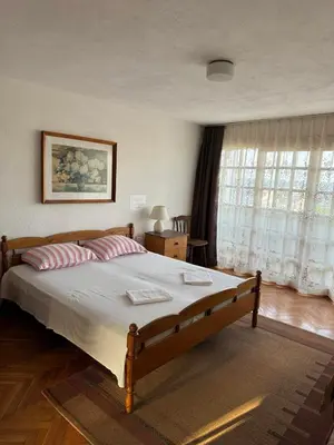 a bedroom with a large bed with two pillows at obzor, orkinos in Obzor