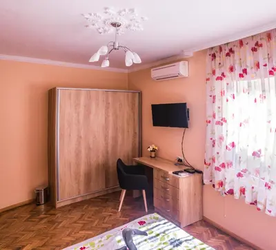 a room with a bed and a desk and a cabinet at Two Bedroom Apartment Downtown Ivanovi in Varna City