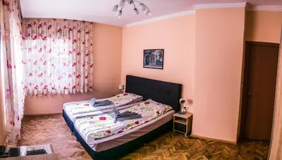 a bedroom with a bed in a room with pink walls at Two Bedroom Apartment Downtown Ivanovi in Varna City