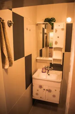 a bathroom with a sink and a mirror at Two Bedroom Apartment Downtown Ivanovi in Varna City