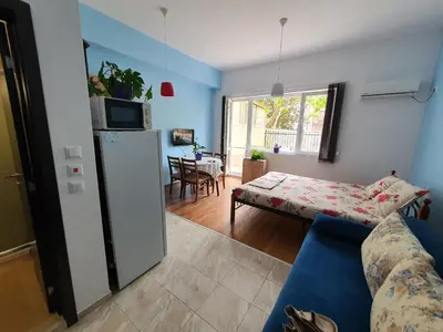 a living room with a couch and a refrigerator at Flowers Studio in Pomorie