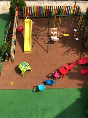 an overhead view of a playground with chairs and a play equipment at Sunny Paradise Family Hotel in Kiten