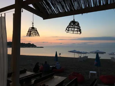 people sitting on the beach watching the sunset at Sunny Paradise Family Hotel in Kiten
