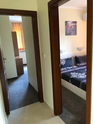 a mirror in a room with a bed in it at Sunny Paradise Family Hotel in Kiten