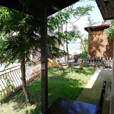 a view from the porch of a house with a table and chairs at Villa Izgrev 24а in Chernomorets