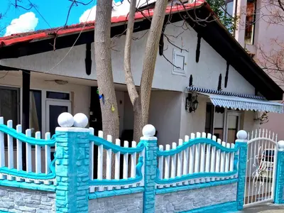 a white picket fence in front of a house at Villa Izgrev 24а in Chernomorets