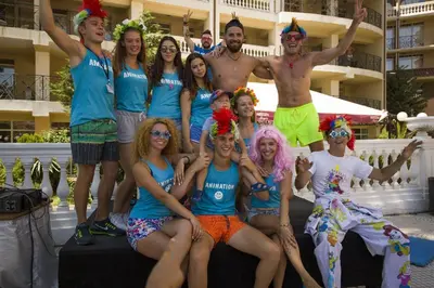 a group of people dressed in costumes posing for a picture at Royal Bay Hotel - All Inclusive in Elenite