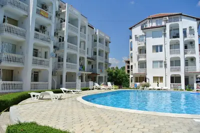 a swimming pool in front of a large apartment building at Bravo 5 Holiday Home in Sunny Beach