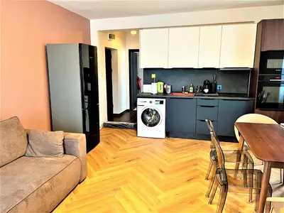 a living room with a couch and a kitchen at Bravo 5 Holiday Home in Sunny Beach