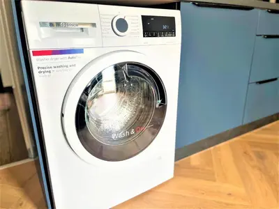 a white washing machine sitting in a kitchen at Bravo 5 Holiday Home in Sunny Beach