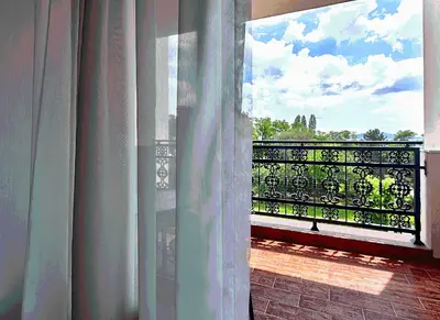 an open window with a view of a balcony at Primoretz Grand Hotel & Spa in Burgas City