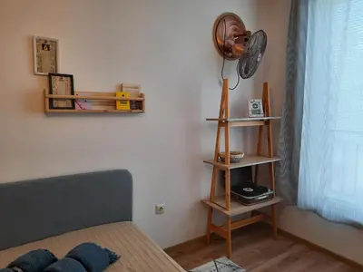 a bedroom with a bed and a fan on the wall at Soulful Apartments - Horizon in Varna City