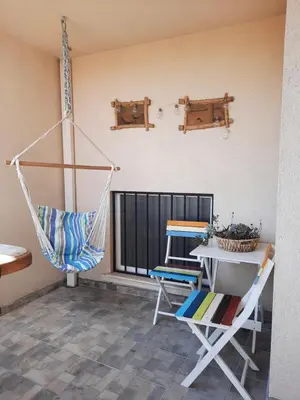a room with a hammock and a table and a chair at Soulful Apartments - Horizon in Varna City