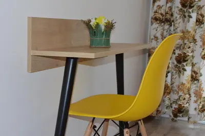 a table and a yellow chair in a room at Villa Valentines in Kiten