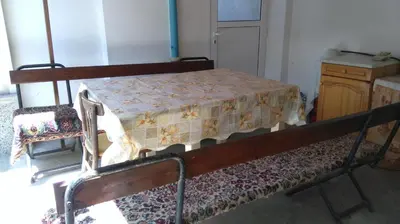 a bed sitting in a room with a table at Песента на морето in Obzor
