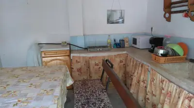 a kitchen being remodeled with a table and a counter at Песента на морето in Obzor