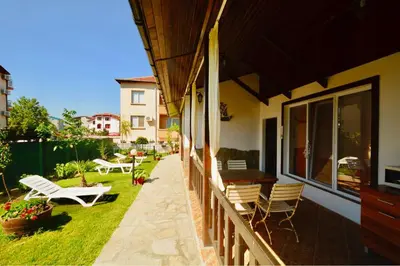 a balcony of a house with chairs and a table at Villa Yanevi in Lozenets