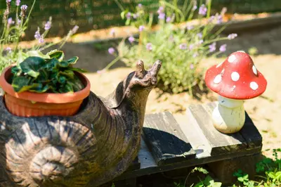 a statue of a bird sitting on a table next to a mushroom at Villa Yanevi in Lozenets