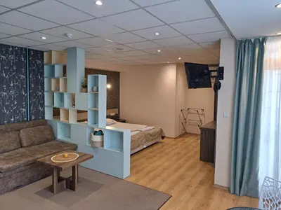 a living room with a bed and a couch at Hotel City in Burgas City