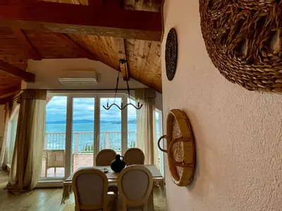 a dining room with a table and a view of the ocean at Casa de oro Alma in Sozopol