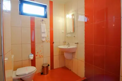 a bathroom with a toilet and a sink at Guest House Daris in Sozopol