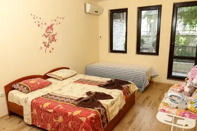 two beds in a room with two windows at Complex Sozopol Dreams BMT in Sozopol