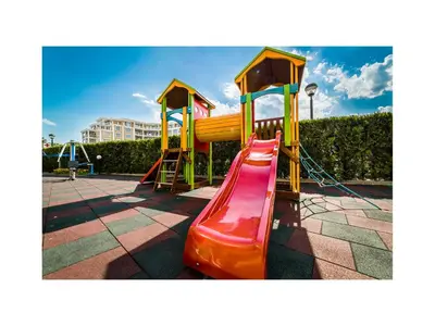 a playground with a slide in a park at Hotel Golden Dune in Sunny Beach