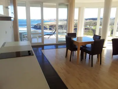 a kitchen and dining room with a table and chairs at Aparthotel Romance in Kiten
