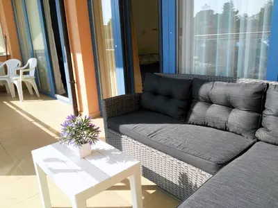 a living room with a couch and a table at Apartment Konstantin in Trakia Plaza in Sunny Beach