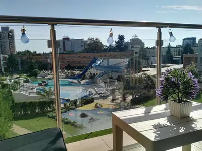 a balcony with a view of a pool and a playground at Apartment Konstantin in Trakia Plaza in Sunny Beach