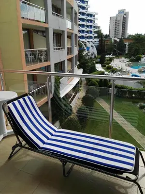 a blue and white chair sitting on a balcony at Apartment Konstantin in Trakia Plaza in Sunny Beach