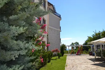 a house with flowers on the side of it at Apartment on the Cliff Obzor in Obzor