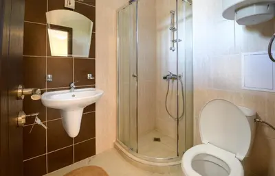 a bathroom with a shower and a toilet and a sink at Apollon Apartments in Nesebar