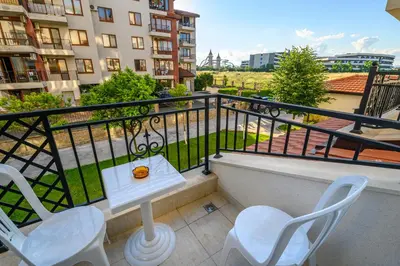 a balcony with two chairs and a table on it at Apollon Apartments in Nesebar