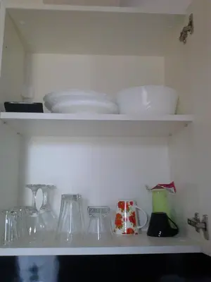 a shelf with plates and bowls and other dishes at Apartments in Casa del Sol in Sunny Beach