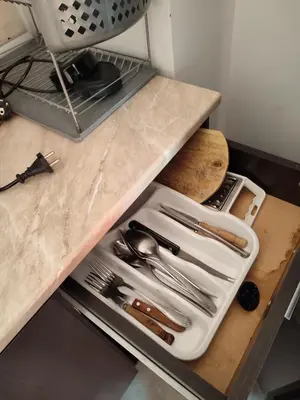 a drawer in a counter with utensils on it at Apartament Janet in Pomorie