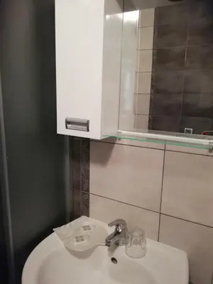 a bathroom with a white sink and a mirror at Apartament Janet in Pomorie
