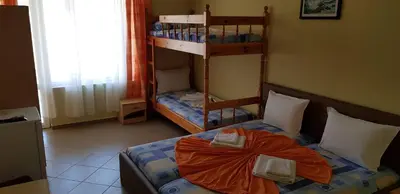 a bedroom with a bed and a bunk bed at Hotel Laguna - Guest House in Primorsko