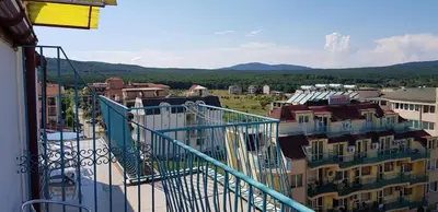 a view of a city from a balcony of a building at Hotel Laguna - Guest House in Primorsko