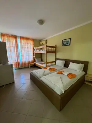 a bedroom with a large bed in a room at Hotel Laguna - Guest House in Primorsko