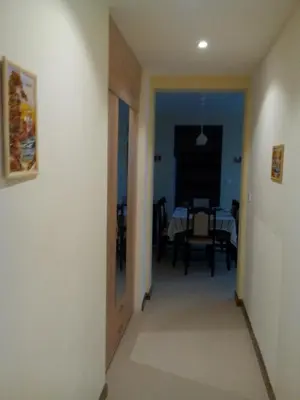 a hallway leading to a dining room with a table at Byala Relax Apartments in Byala