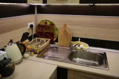a kitchen sink with a dish rack next to it at Byala Relax Apartments in Byala