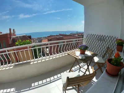 a balcony with chairs and a table and a view of the ocean at Apartment in St. Vlas with terrace in Sveti Vlas