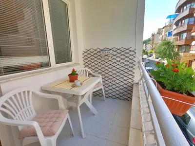 a small balcony with a table and chairs on it at Apartment in St. Vlas with terrace in Sveti Vlas