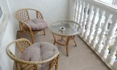 two chairs and a glass table on a staircase at Bravo 5 Sunny Beach in Sunny Beach