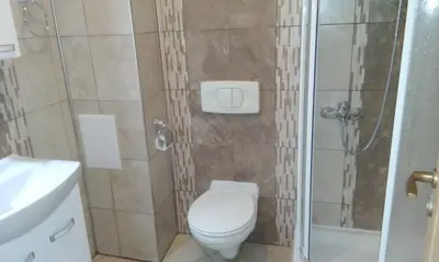 a small bathroom with a toilet and a shower at Bravo 5 Sunny Beach in Sunny Beach