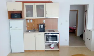 a small kitchen with white cabinets and a microwave at Bravo 5 Sunny Beach in Sunny Beach