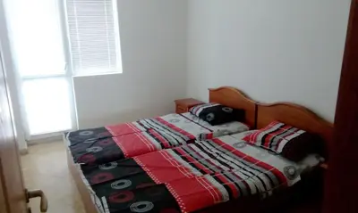 a bedroom with a bed with a quilt on it at Bravo 5 Sunny Beach in Sunny Beach